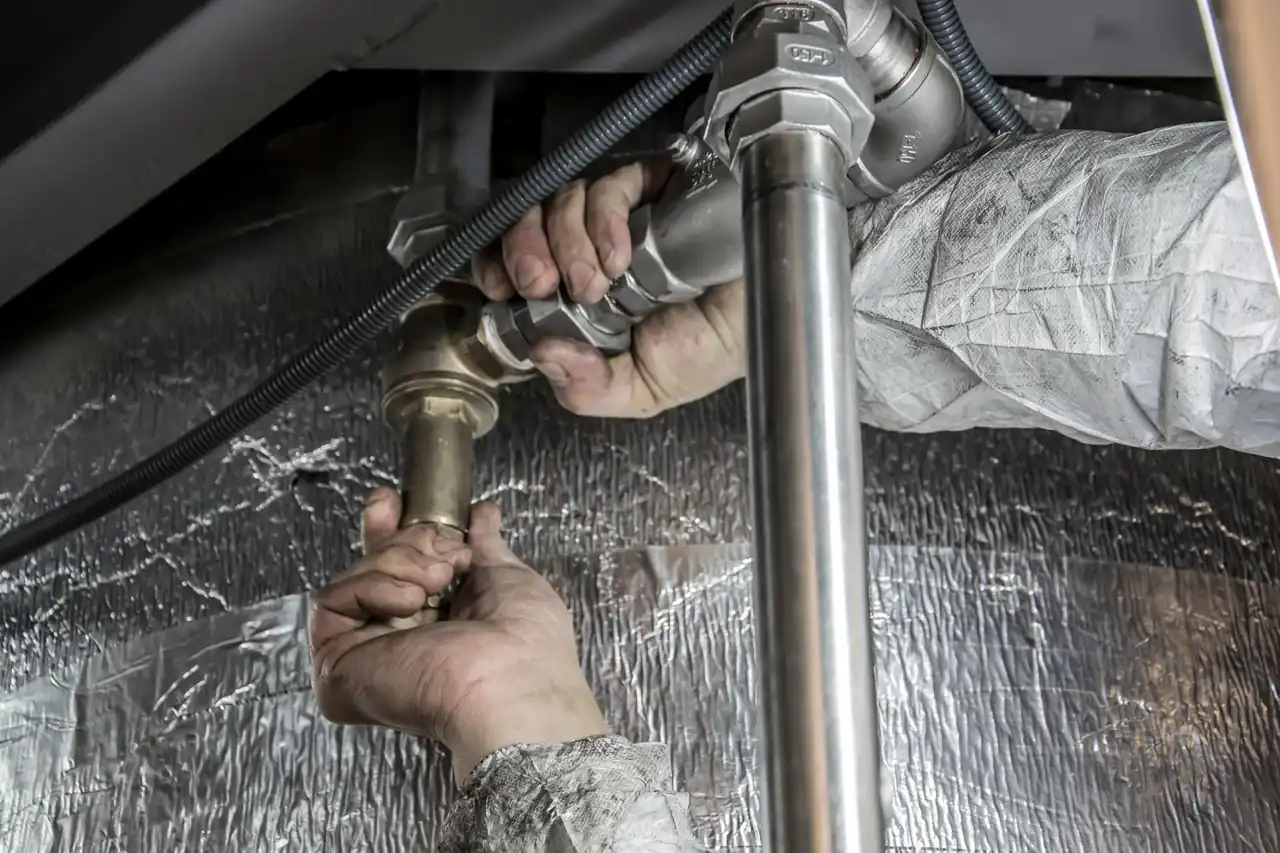 Pipe fittings under a water heating system